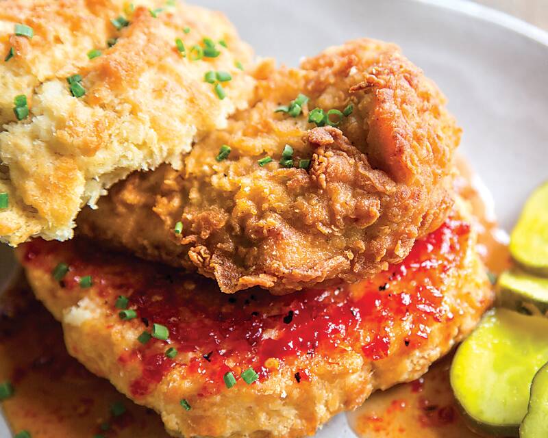 fried chicken biscuit sandwich with pickles and pepper jelly