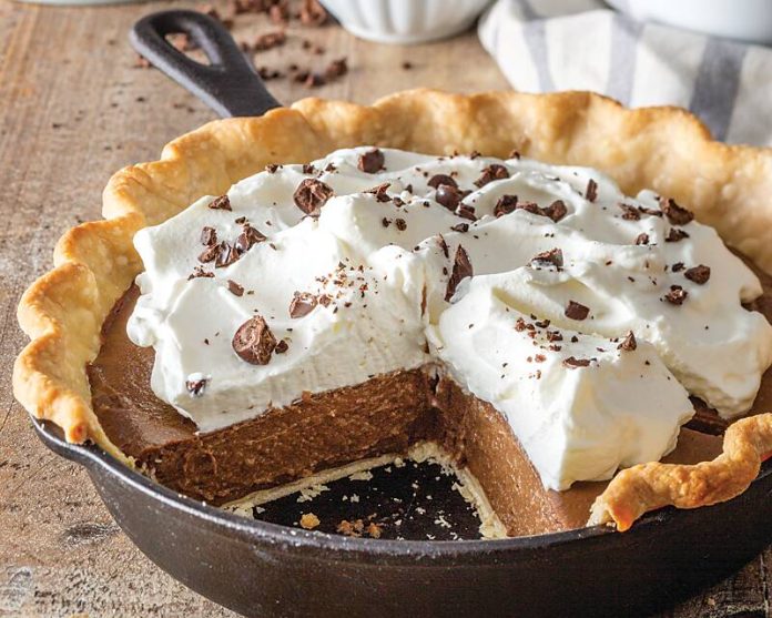 Chocolate-Chicory Cream Pie in a skillet resting on a table, a slice already gone!