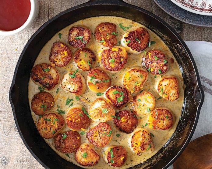 Seared Scallops with Earl Grey Butter Sauce in skillet with cup of tea on the side