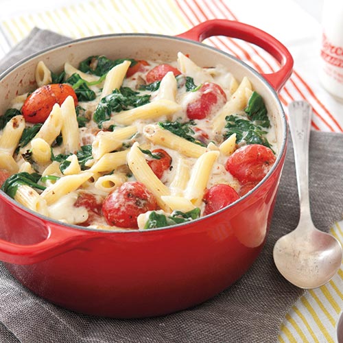 spinach and tomato pasta in red pot
