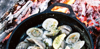 Chef’s Table: Whitney Otawka Whitney Otawka's woodfire Clams with fennel and lemon in a skillet on an open fire pit
