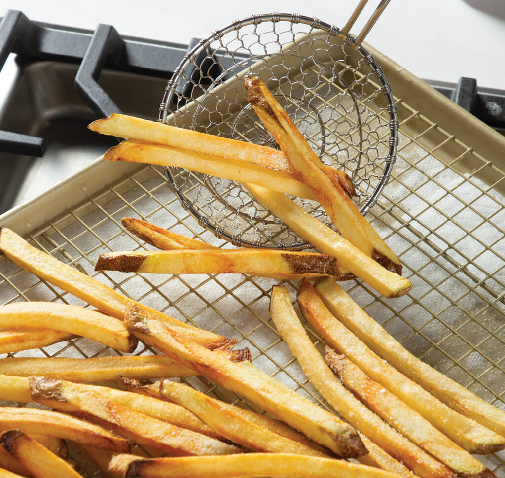 Step 6. Gently remove the fries with a slotted spatula and let drain on a wire rack lined with paper towels. Let cool slightly.