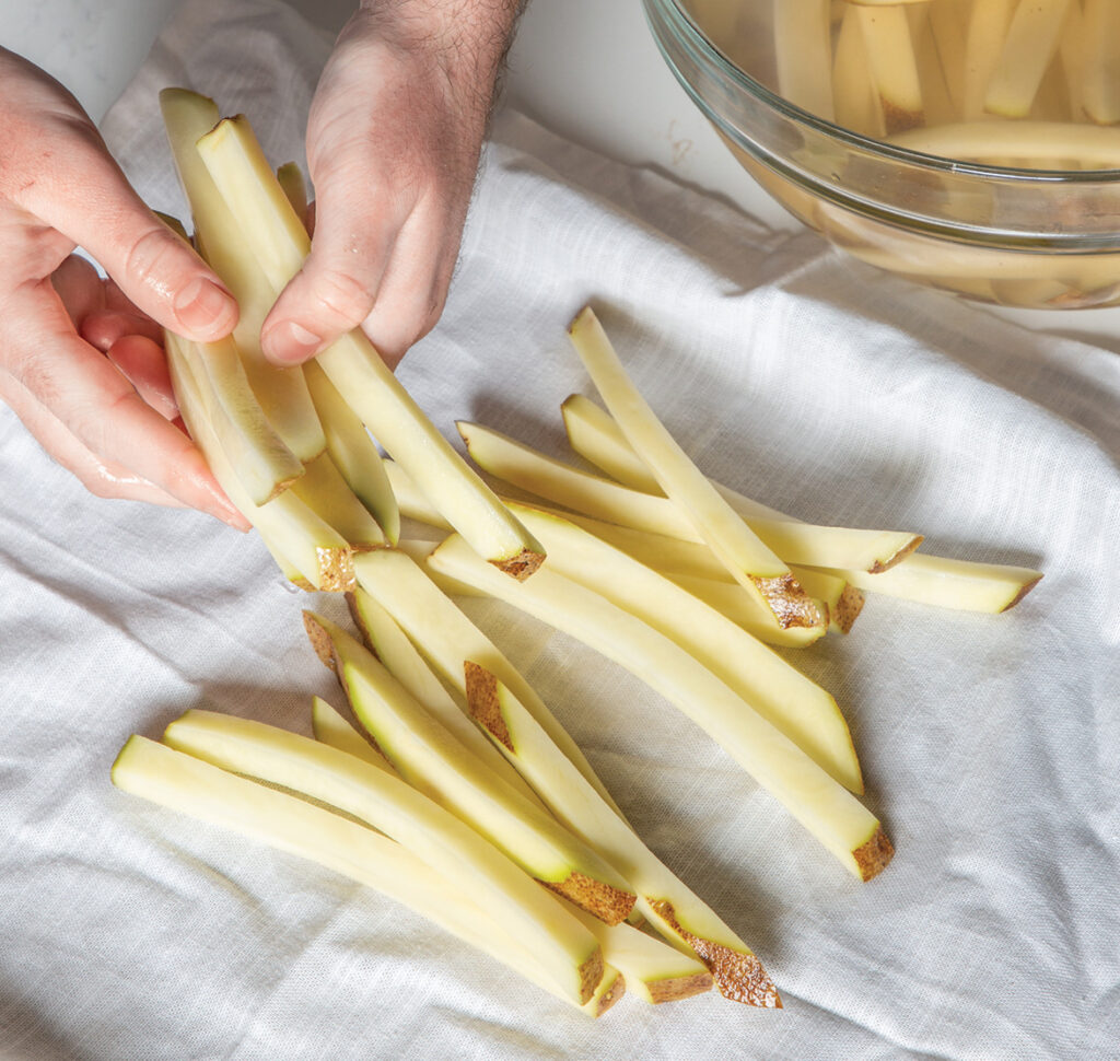 Step 3. Dry: Reduce oil splattering by gently patting the potatoes dry with a paper towel.