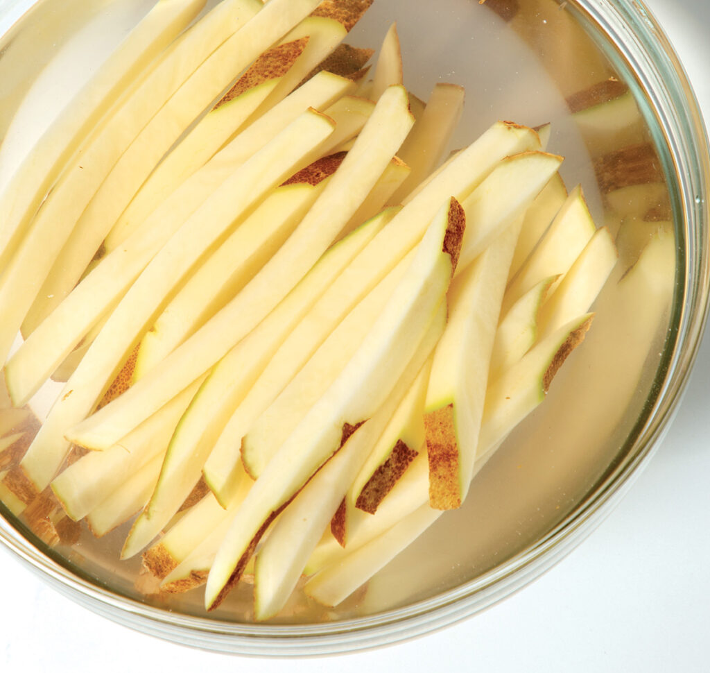 Step 2. Soak: Soaking the potatoes in cold water helps draw out starch and yields a fluffier fry.