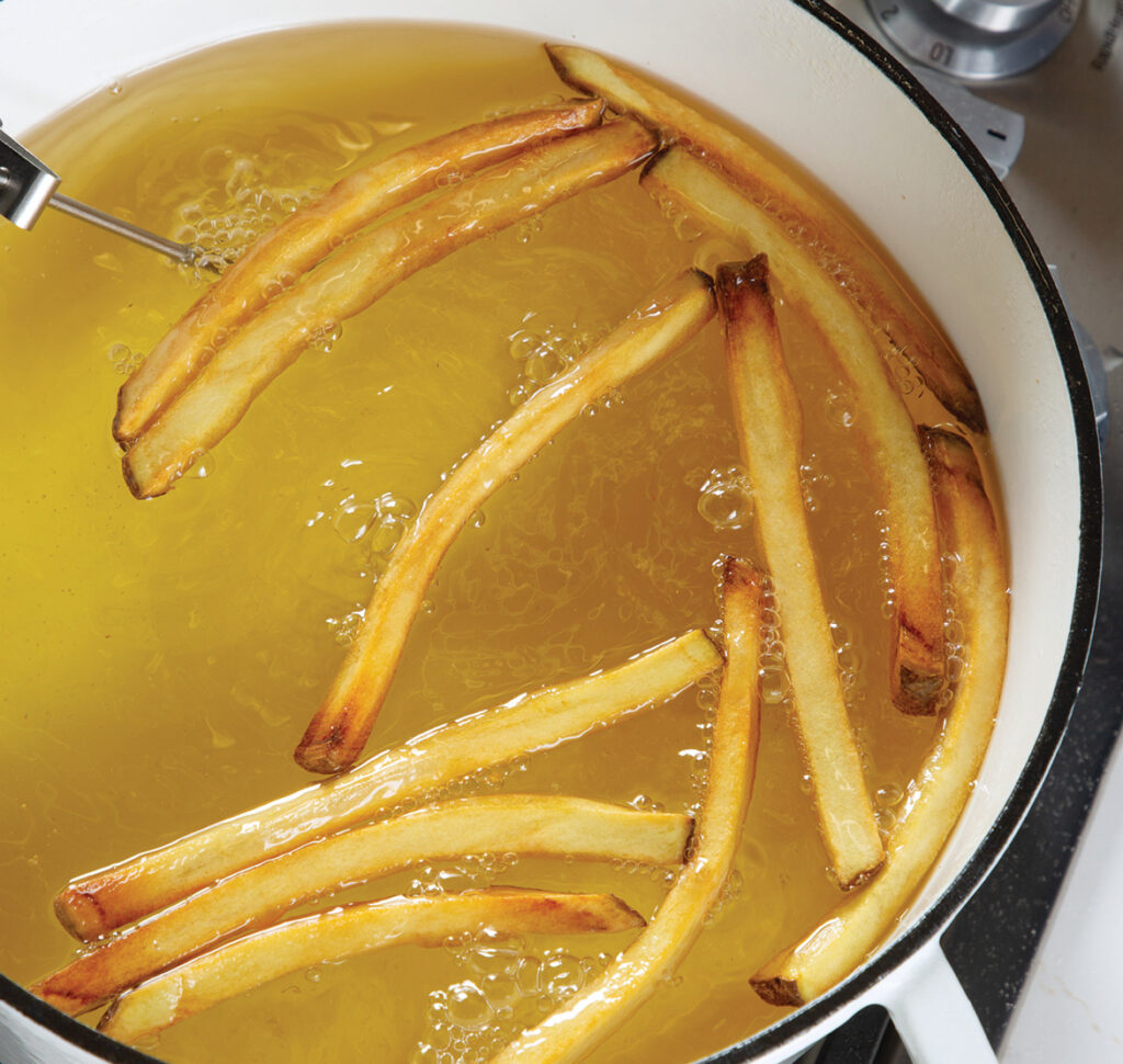 Step 6. Second Cook: Increase the heat to medium-high, and heat the oil to 400°. Working in batches, fry the potatoes until golden, about 5 minutes more.