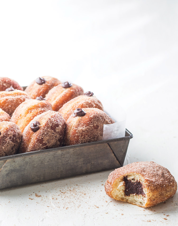 Bring the pastry shop to your home with these chocolate-filled Cinnamon Hot Chocolate Doughnuts.
