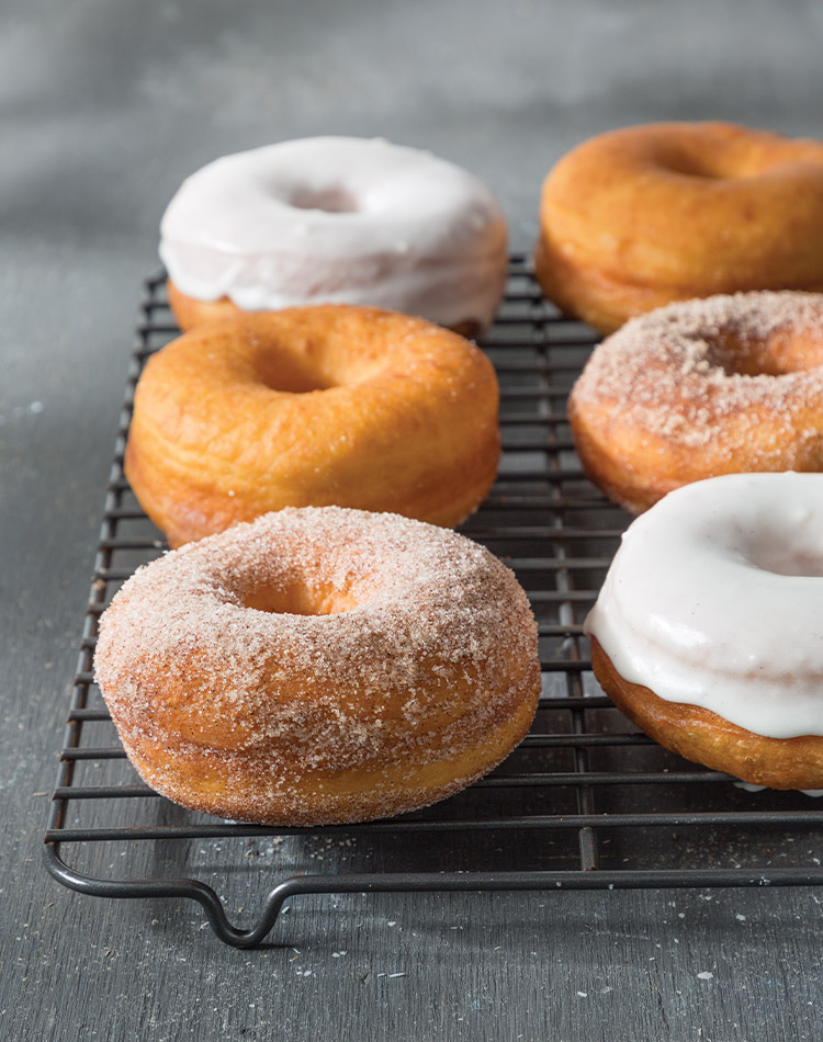 Savor the airy perfection of our Yeast Doughnuts, flawlessly complemented by a smooth layer of decadent Vanilla Bean Frosting.