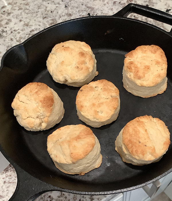 Biscuits arranged on a cast-iron skillet